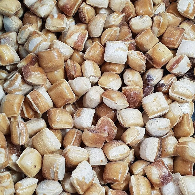 Close-up of a pile of dried split peas in various shades of brown and beige.