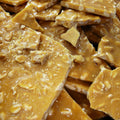 Close-up of peanut brittle with a crumbly texture