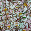 Colorful candy mix with various shapes and sizes on a textured surface