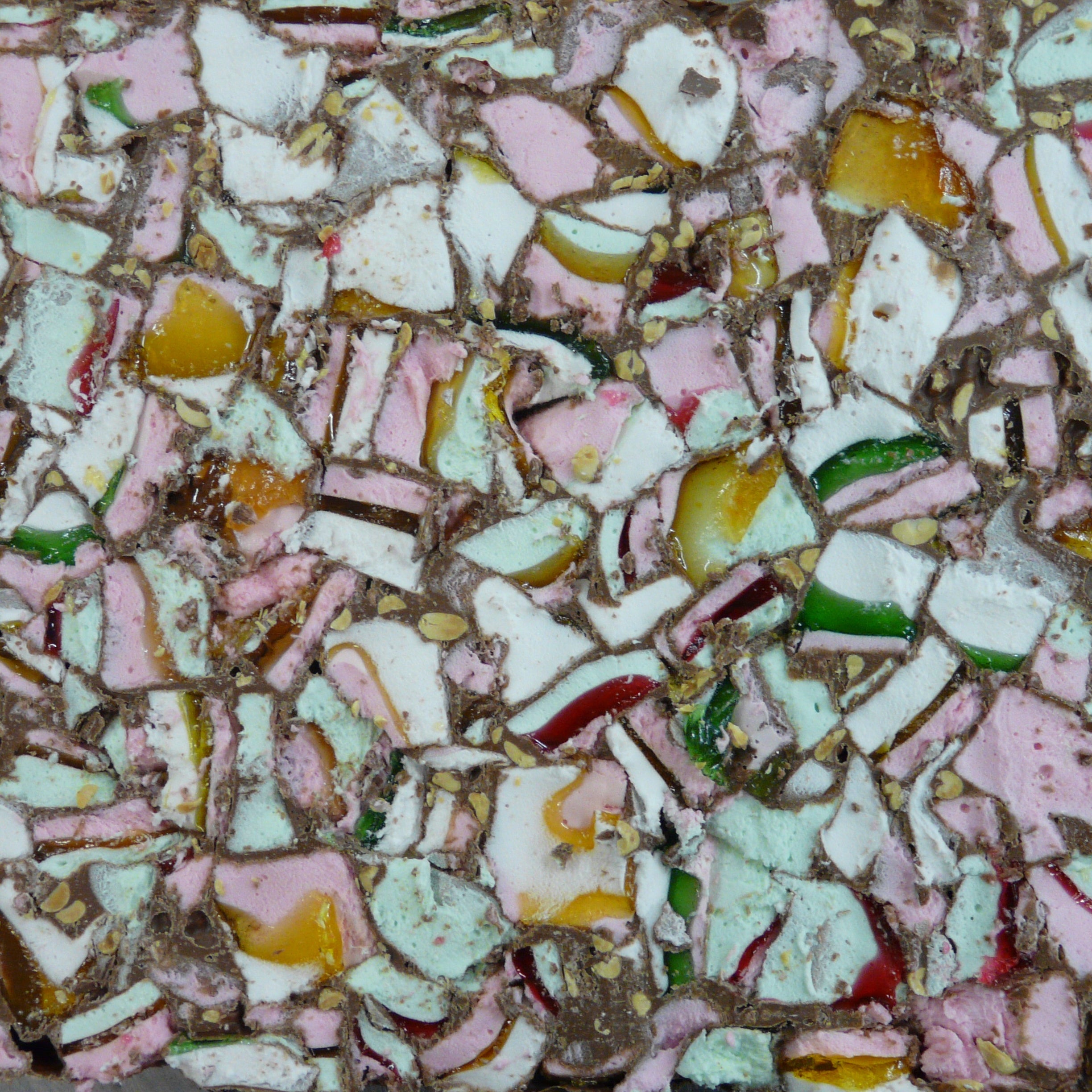 Colorful candy mix with various shapes and sizes on a textured surface