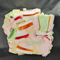 Colorful layered marshmallow block on a dark background