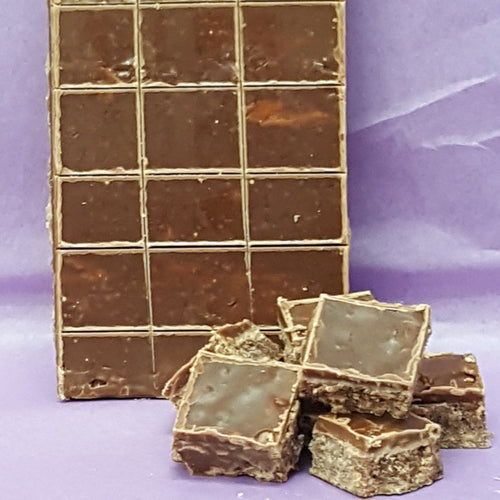 Stack of chocolate bars with a few pieces on a purple background