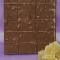 Chocolate bar with a purple background and gummy bears on the side