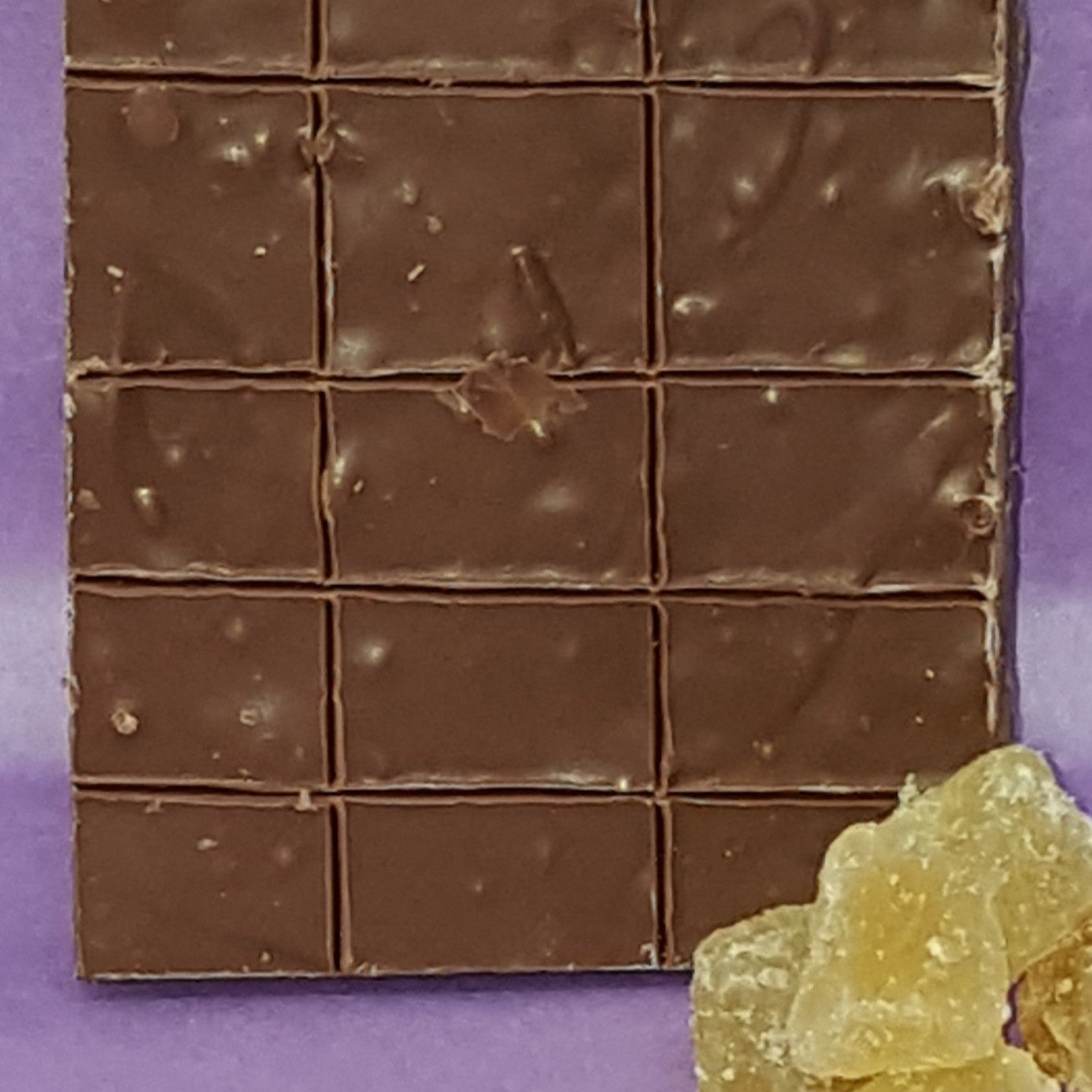 Chocolate bar with a purple background and gummy bears on the side