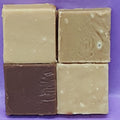 Four square fudge in different colors on a purple background