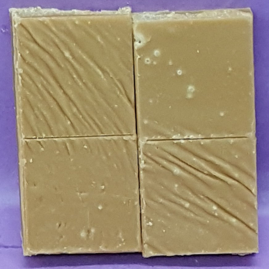 Two square fudge with wavy texture on a purple background