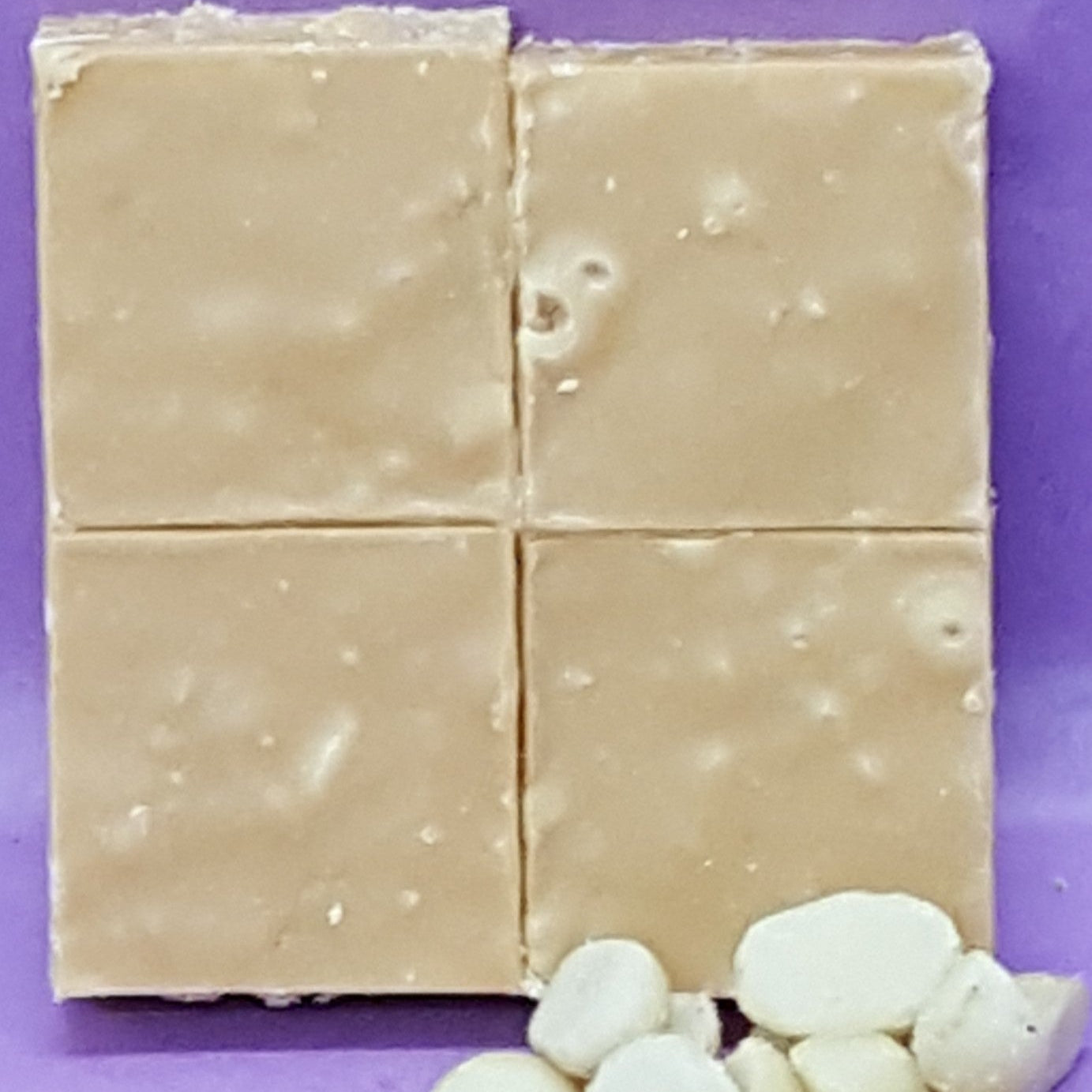 Block of white chocolate with chips on a purple background